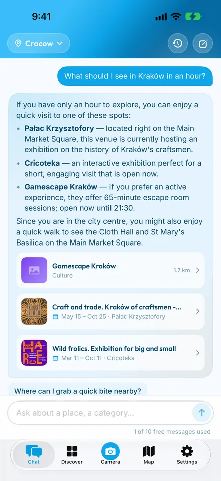 CityChat chat in Kraków — asked what to see in an hour, it suggests nearby places and current exhibitions, each with a card to tap